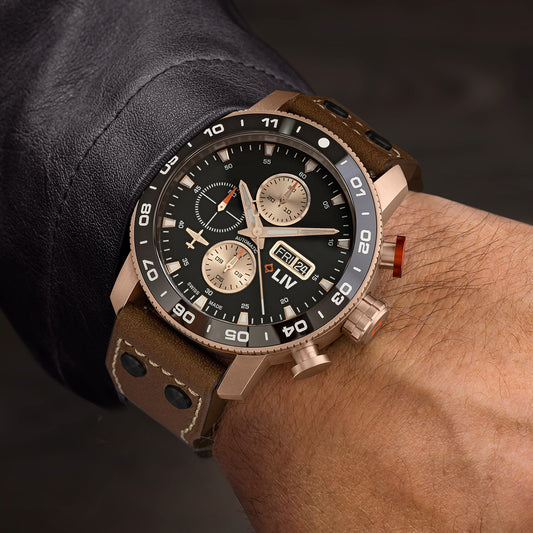 LIV P-51 Chrono Luxury watch with brown leather strap on the wrist against a dark background