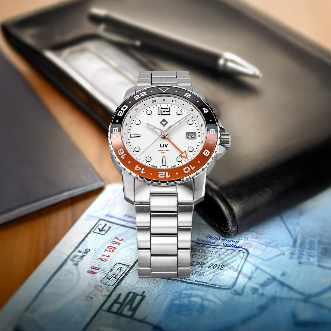 Trekker GMT Summit White on the stainless steel bracelet, resting on a desk with blueprints