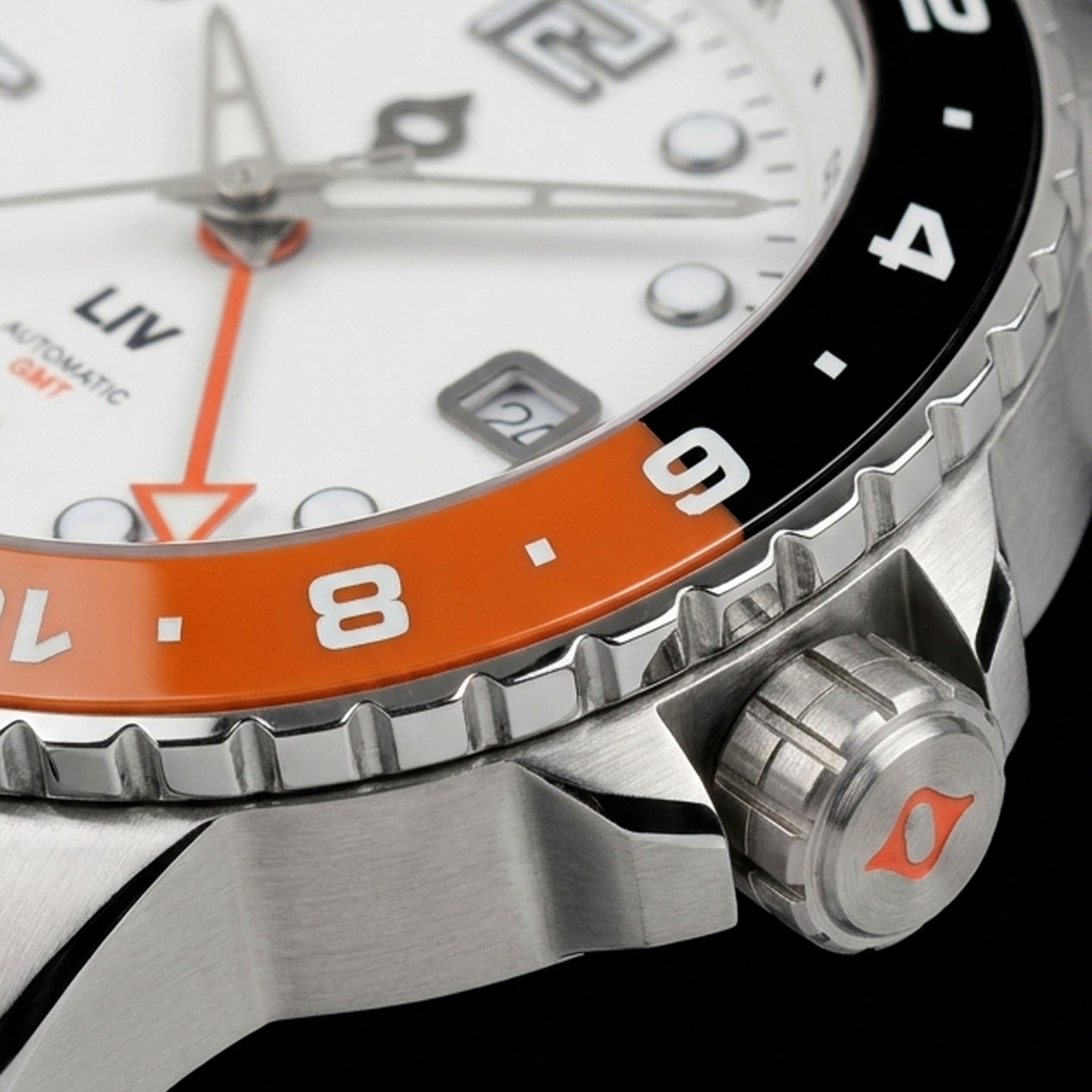 Side close-up of the Trekker GMT Summit White crown and case flank, with the day/night ceramic bezel edge and white dial